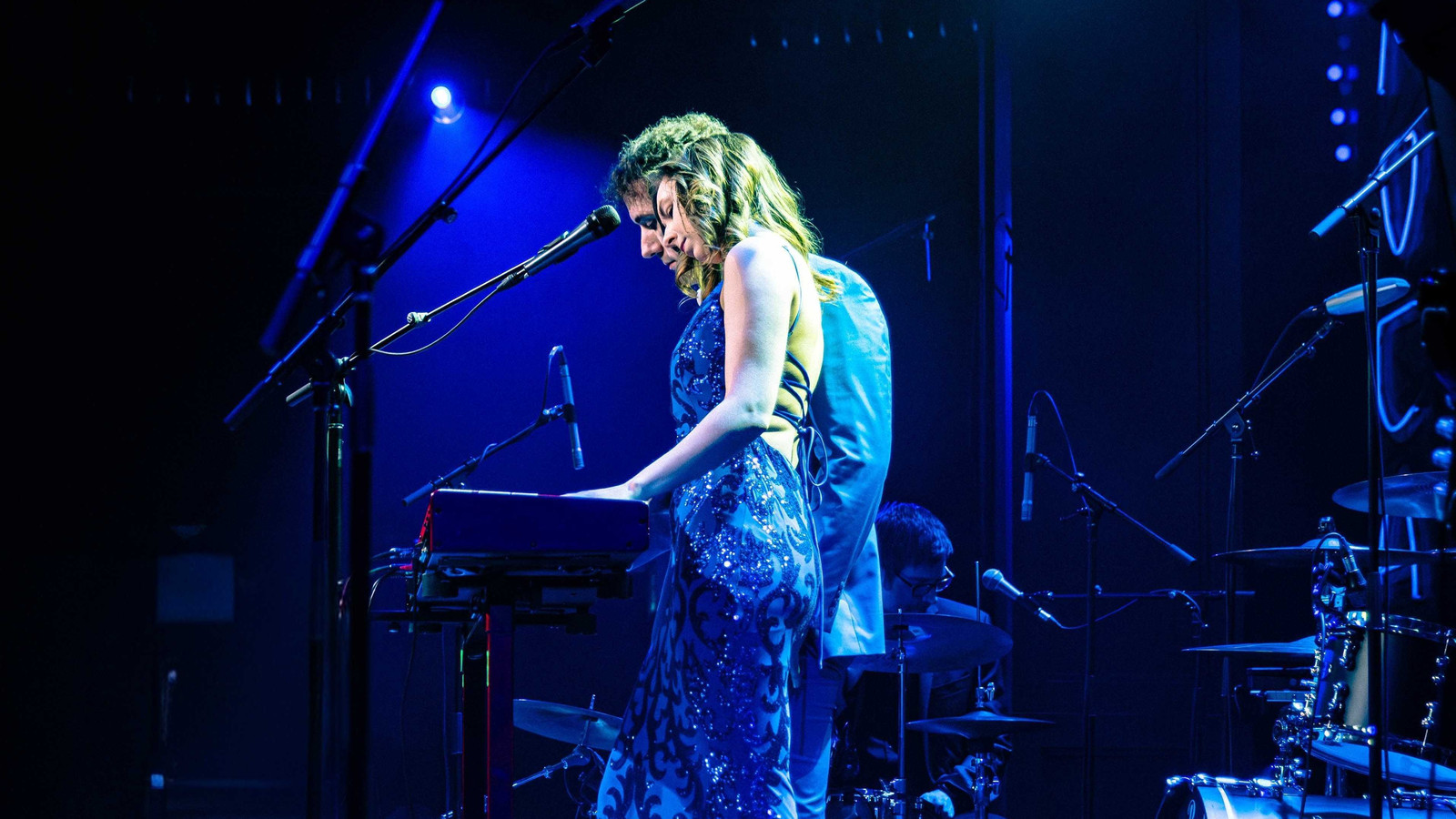 Sasha Kristoff of Awake & Dreaming at the keys under blue stage light, Stefan Schneider behind her, El Mocambo, Toronto