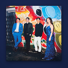 Inevitable printed inner sleeve, photo side: Awake & Dreaming in front of a graffiti wall