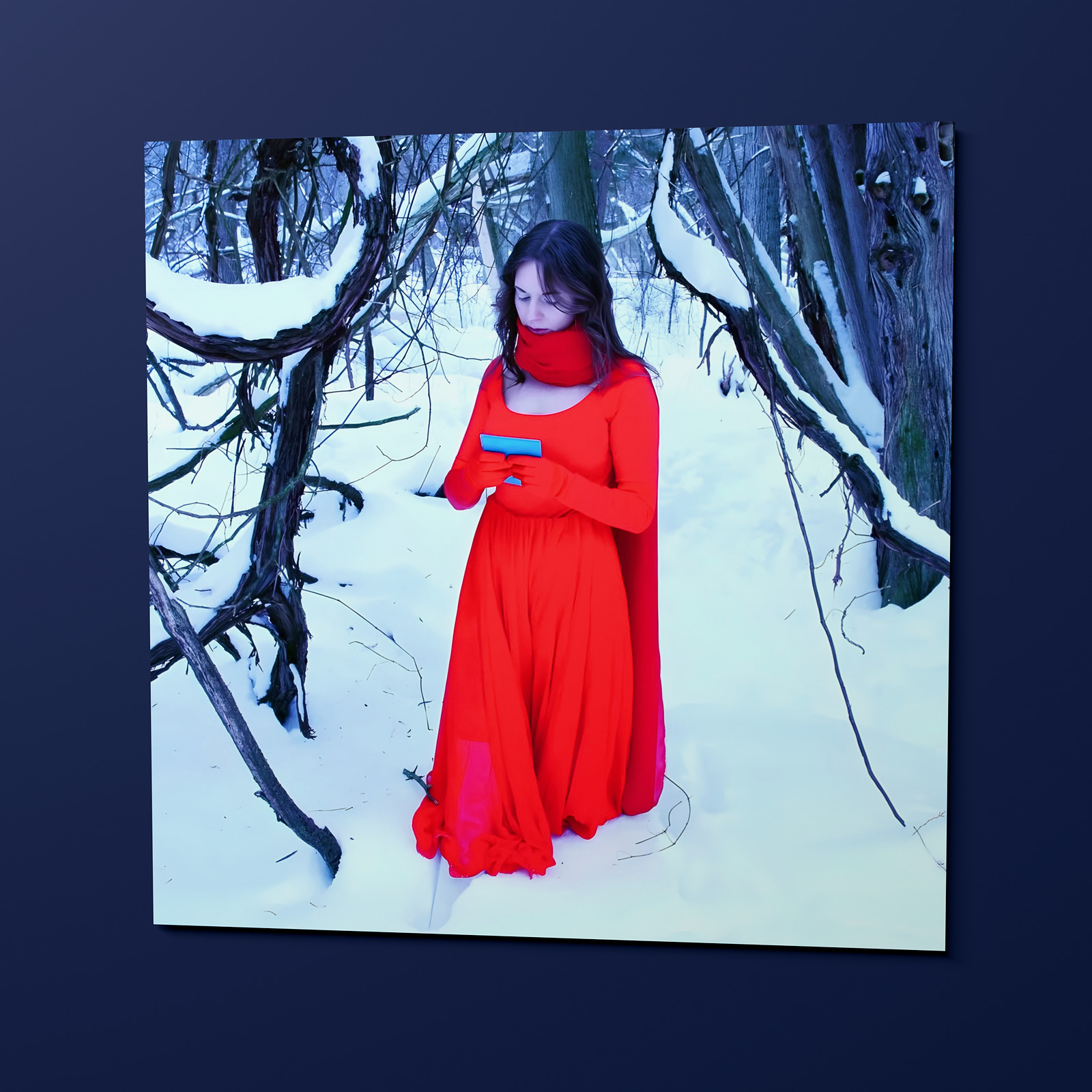 The Note Poster, an 18 by 18 inch matte print hung on a wall: Sasha in the red dress, holding the note she found in the snow